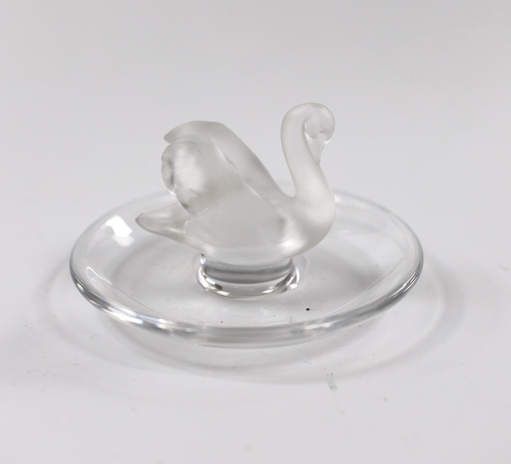 Two Lalique glass paperweights modelled as pecking birds, together with another Lalique swan modelled pin dish